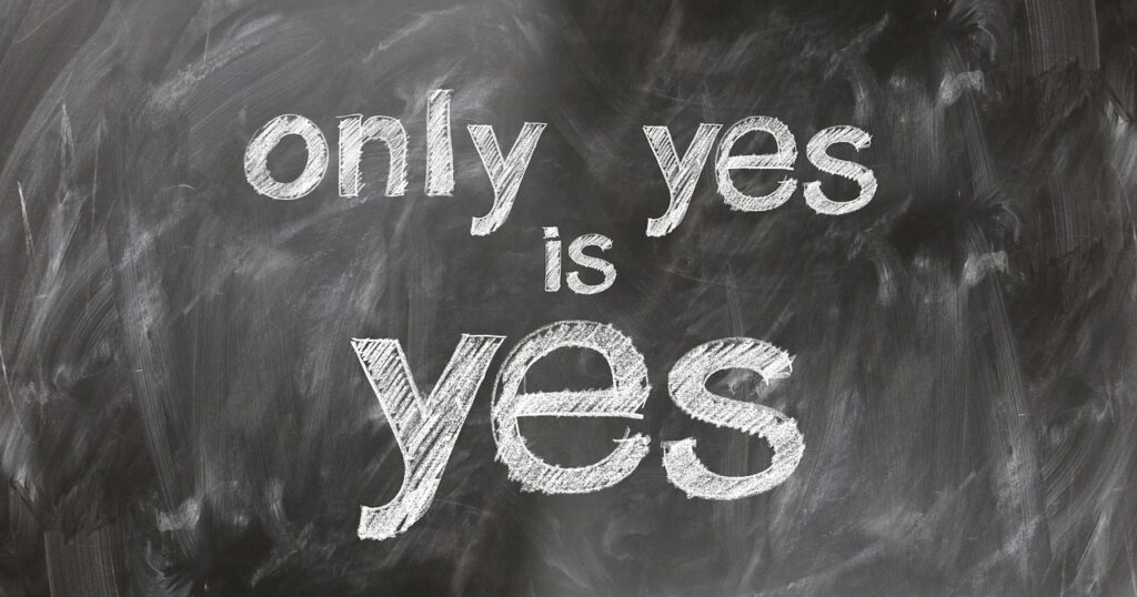 A chalkboard with the affirmation "only yes is yes" written in large white letters