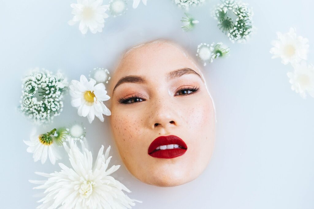 Ethereal beauty routine with white and green floral accents.